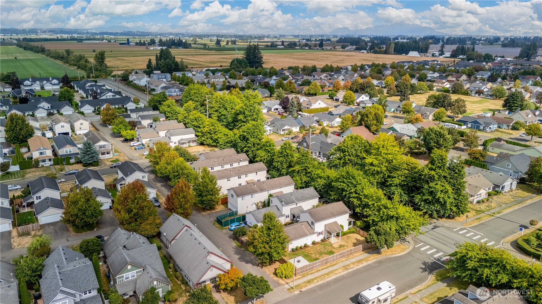 Aerial view of a Lynden neighborhood, with farmland and distant mountains beyond.