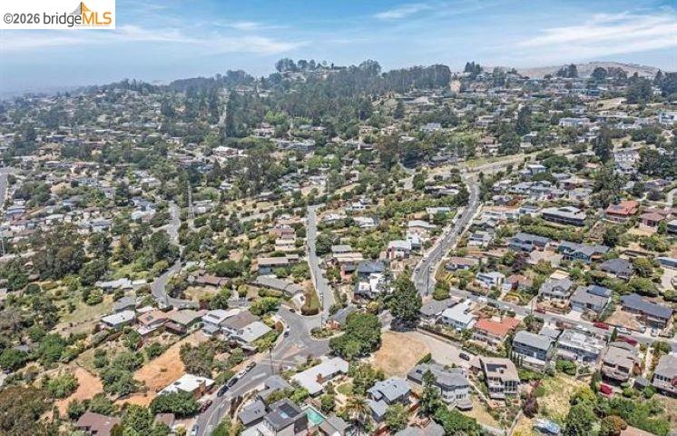 Aerial view of a hillside neighborhood with winding streets and homes.