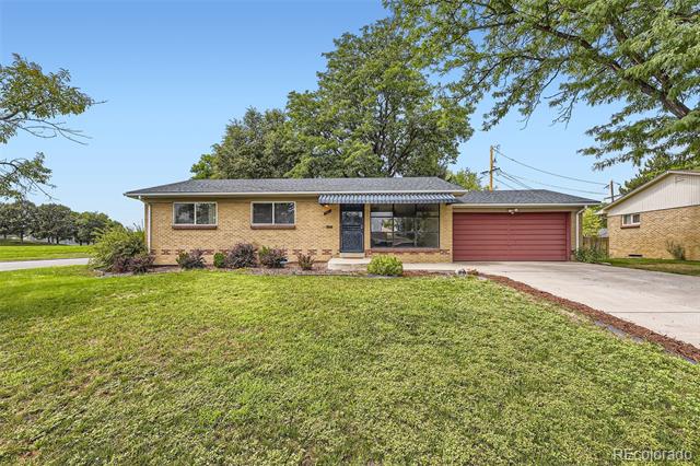 Brick ranch home with a red garage door, covered entry, and broad front lawn.