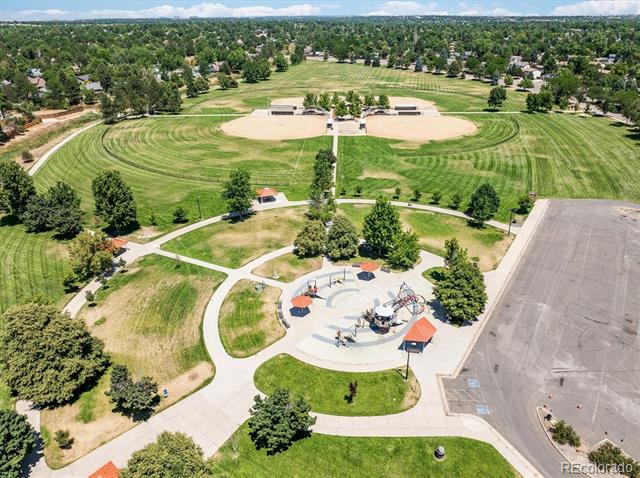 Aerial view of a neighborhood park with baseball fields, walking paths, and a playground.