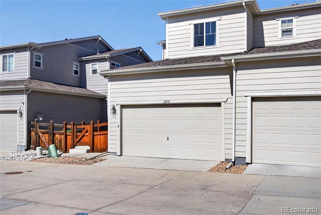 Attached home with a double garage, broad driveway, and fenced side patio.