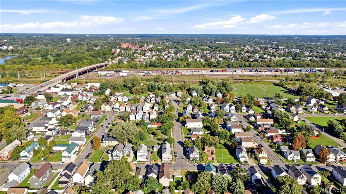 Aerial view of a residential neighborhood with a rail corridor and overpass.