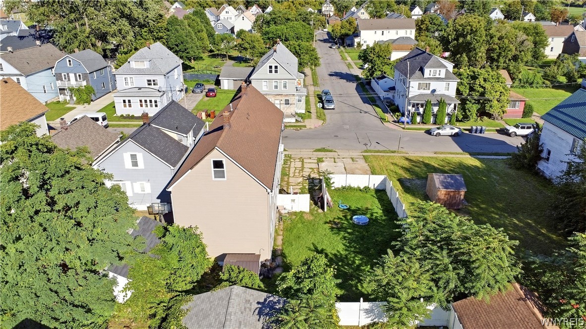 Aerial view of 89 Holland Avenue and its fenced backyard, with neighboring homes and streets beyond.