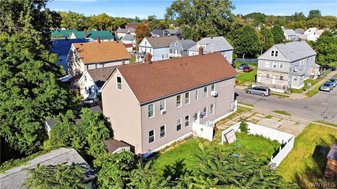 Aerial view of 89 Holland Avenue, a two-story home with a fenced backyard and neighboring houses.
