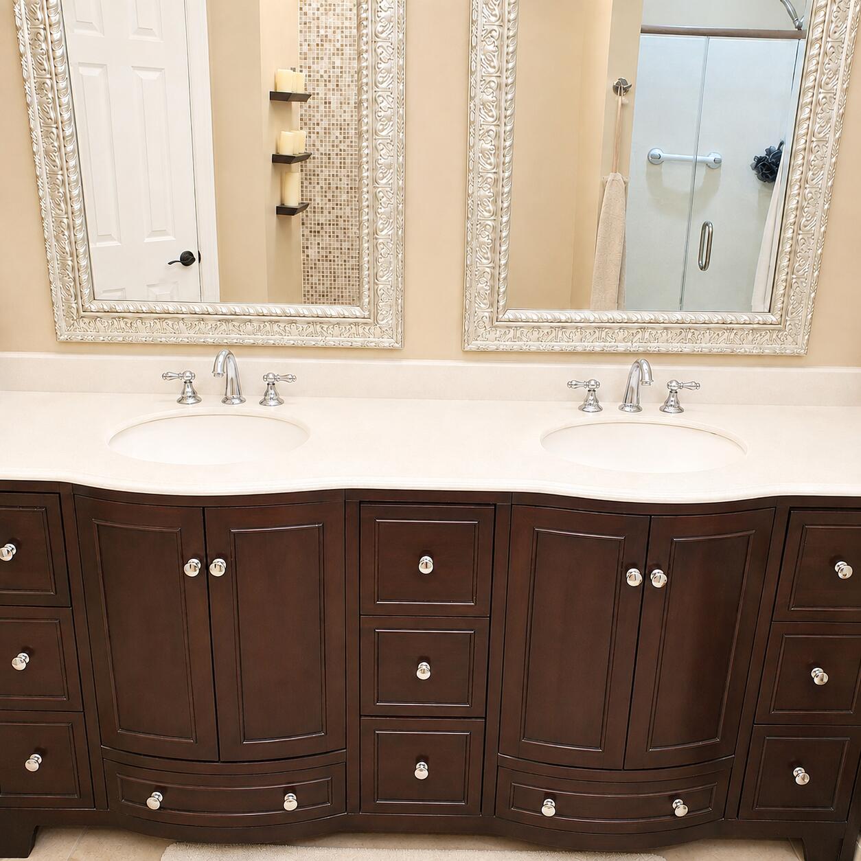 Bathroom double vanity with dark wood cabinetry, two sinks, and ornate framed mirrors.