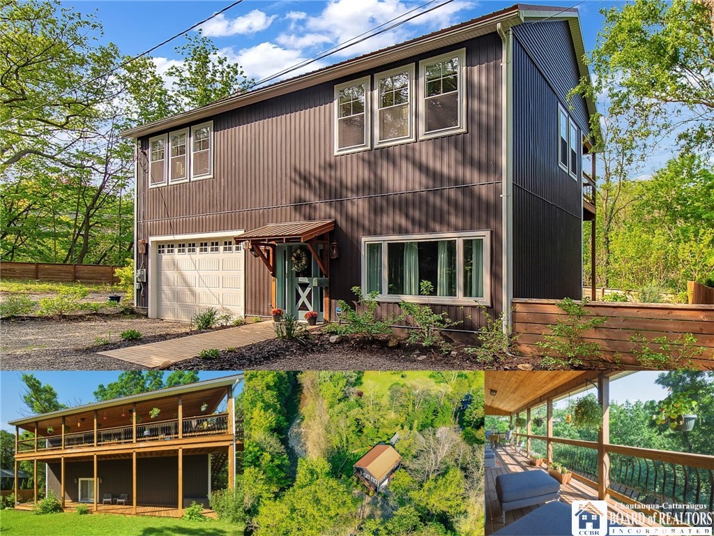 Two-story dark-sided home with an attached garage, covered decks, and a wooded setting.