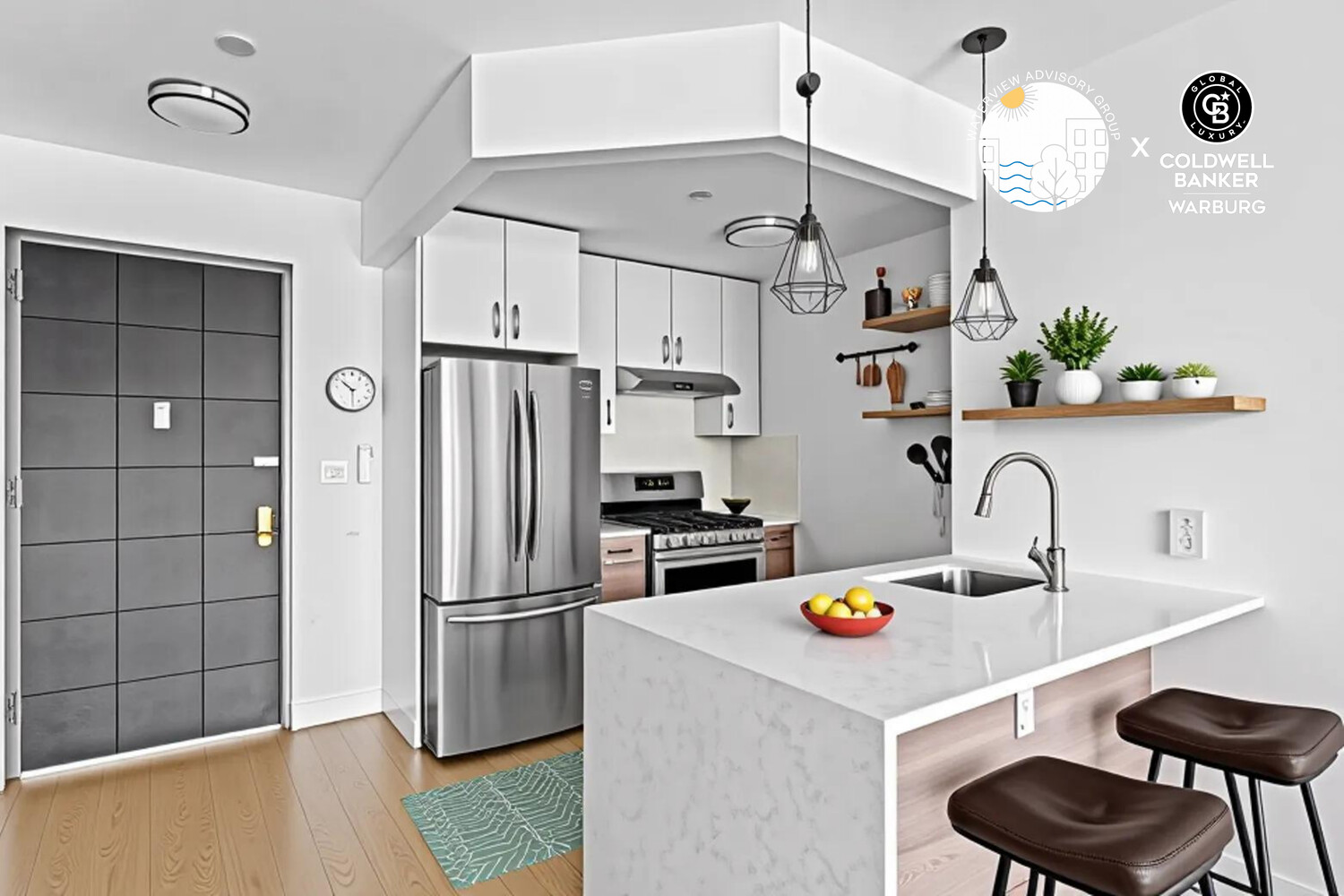 Modern kitchen with a large white island, stainless steel appliances, and pendant lights.