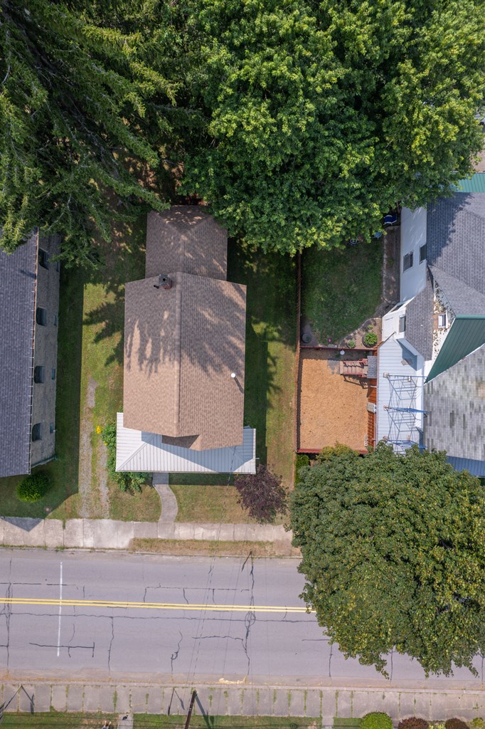 Aerial view of 157 Church, showing its tree-shaded lot, house, and roadside frontage.