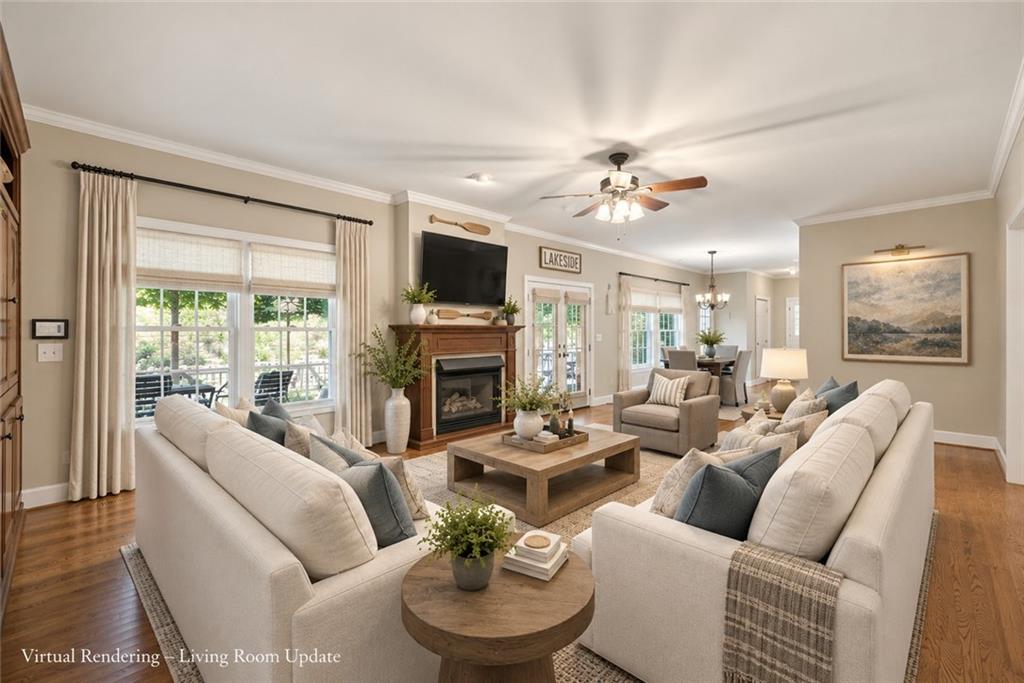 Living room with cream sofas, a fireplace, hardwood floors, and an adjoining dining area.