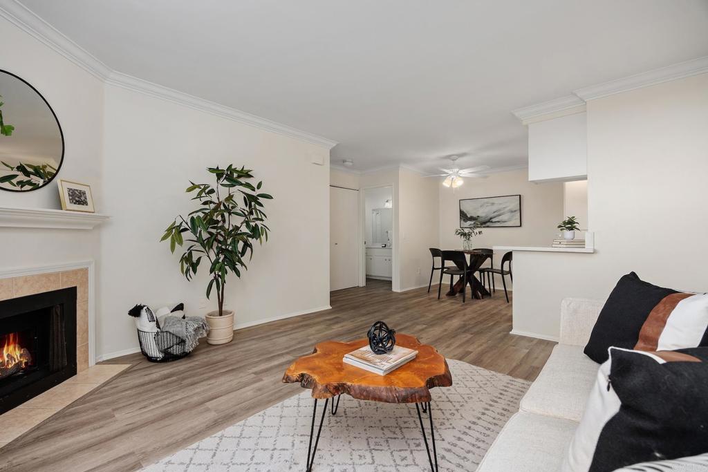 Living room with a fireplace and live-edge coffee table opening to a dining area.