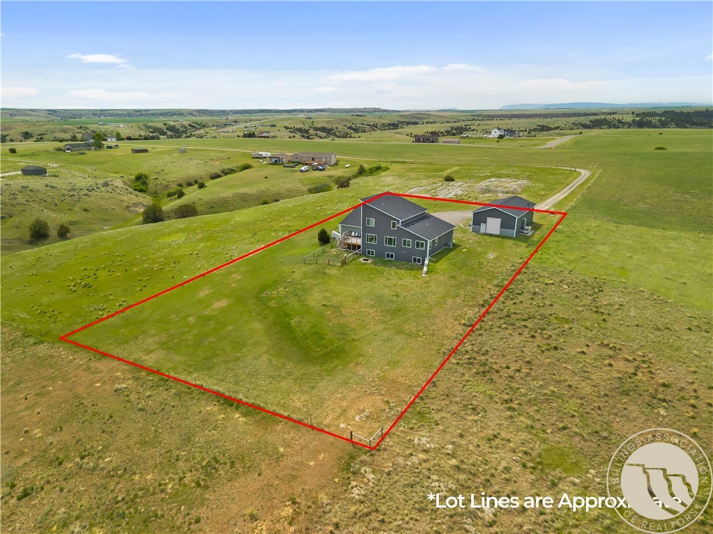 Aerial view of a rural home and detached garage within red approximate lot lines.