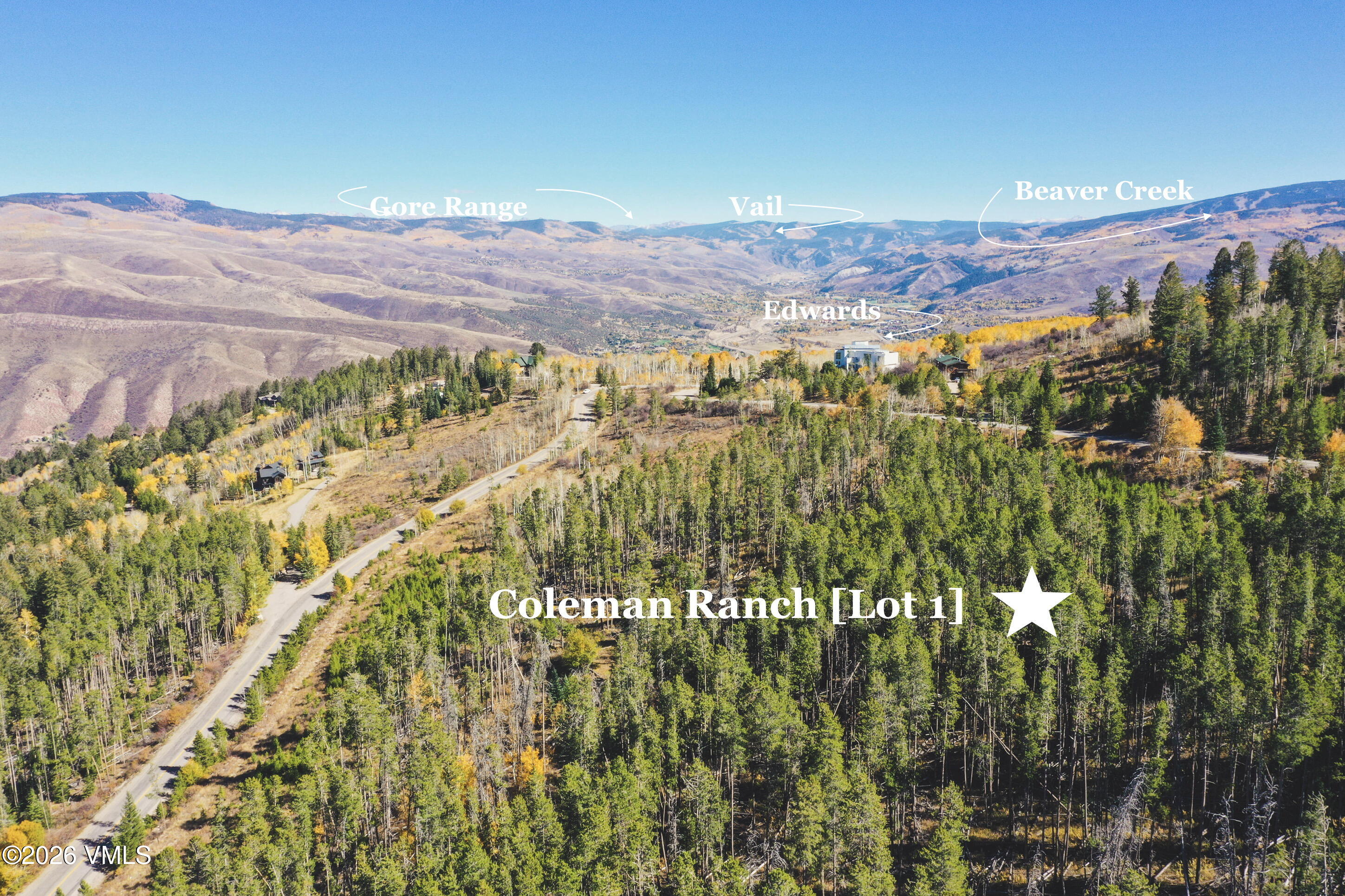Aerial view of wooded Coleman Ranch Lot 1, with a winding road and mountain views labeled Gore Range, Vail, and Beaver Creek.