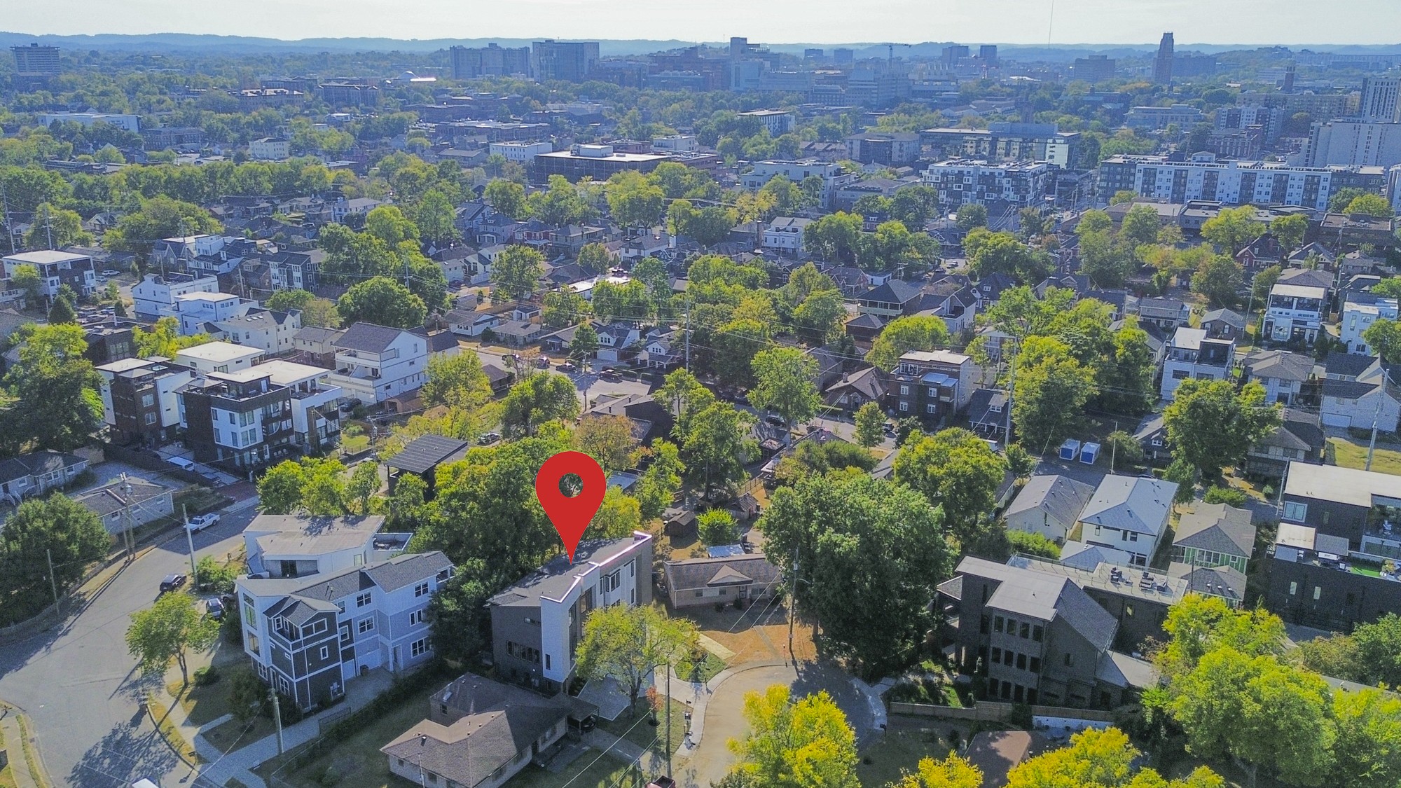 Aerial view of a Southside Circle home, with Nashville’s downtown skyline beyond the leafy neighborhood.