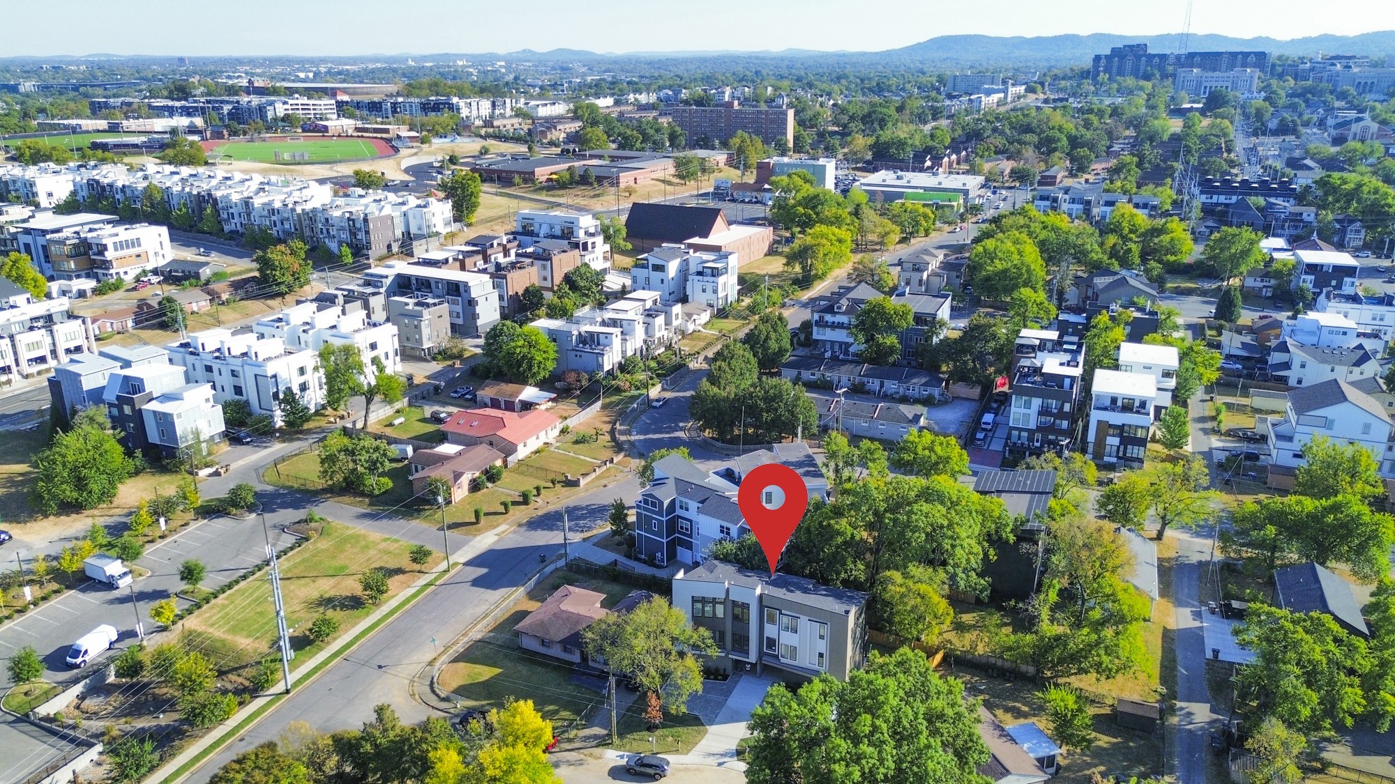 Aerial view of a Nashville neighborhood, with a red map pin marking the property among modern homes.