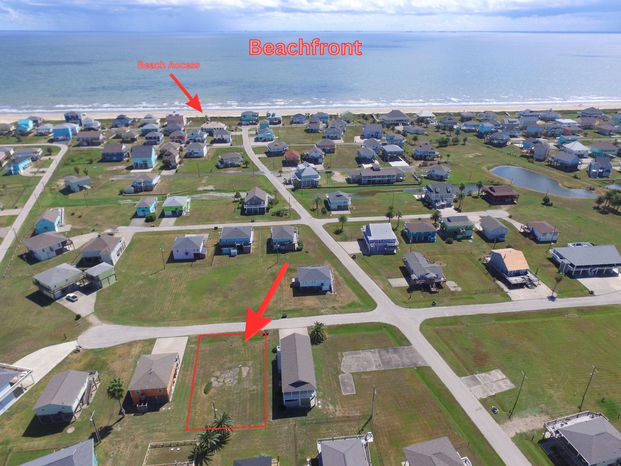 Aerial view of a vacant lot near beachfront homes, with beach access marked.