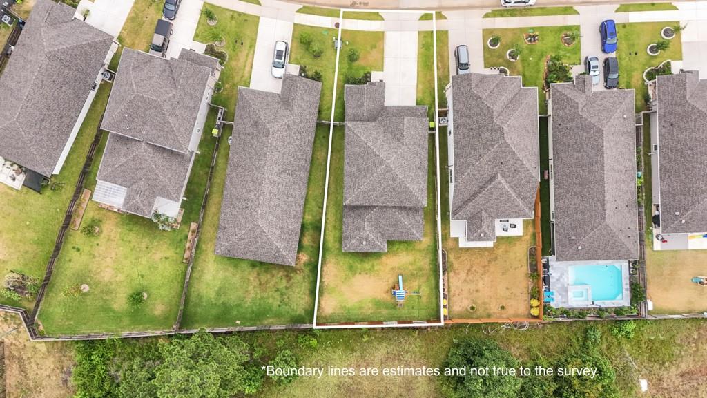 Aerial view of the outlined residential lot between neighboring homes.