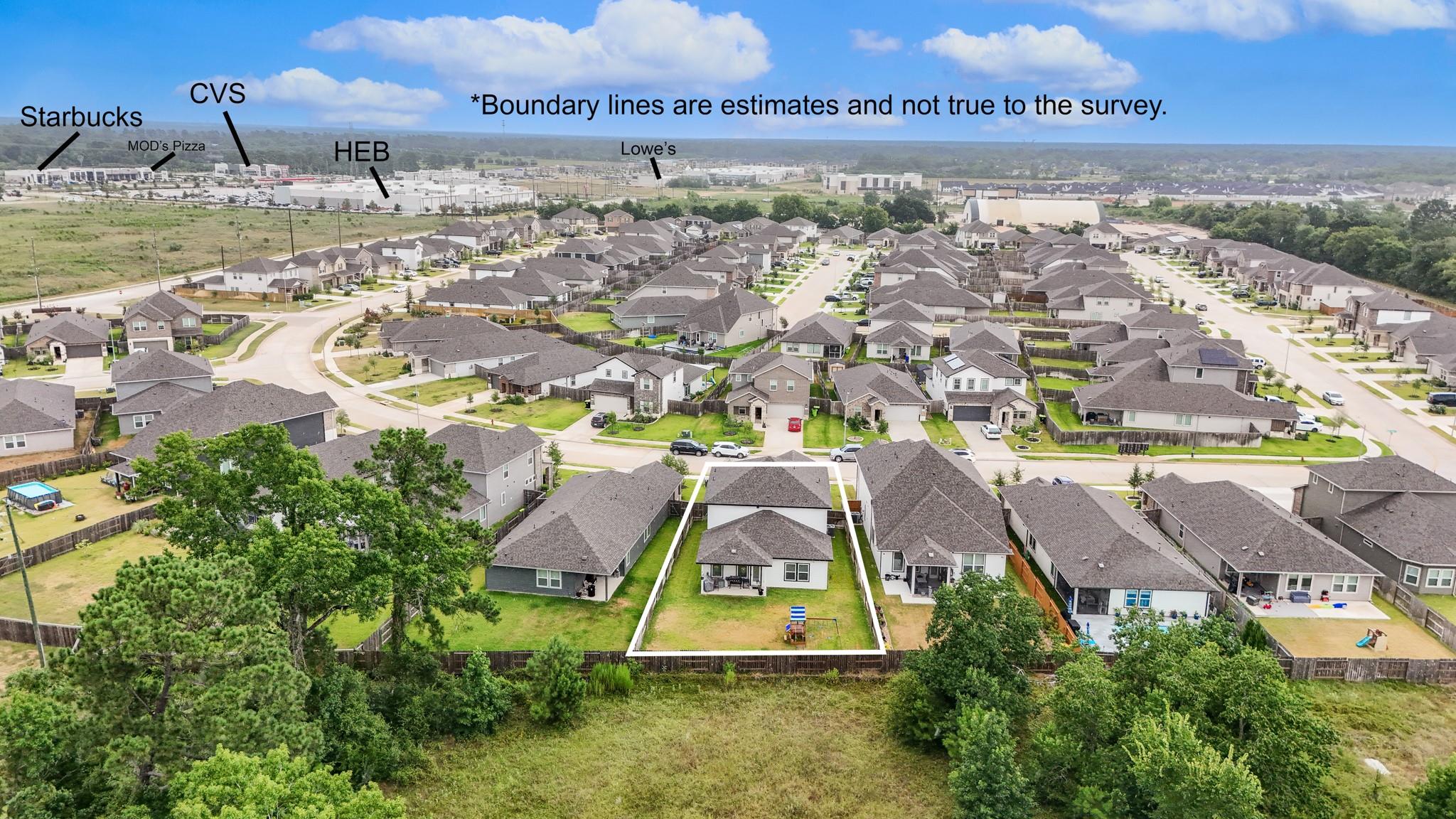 Aerial view of a Magnolia neighborhood with the property lot outlined in white and nearby shopping centers labeled.