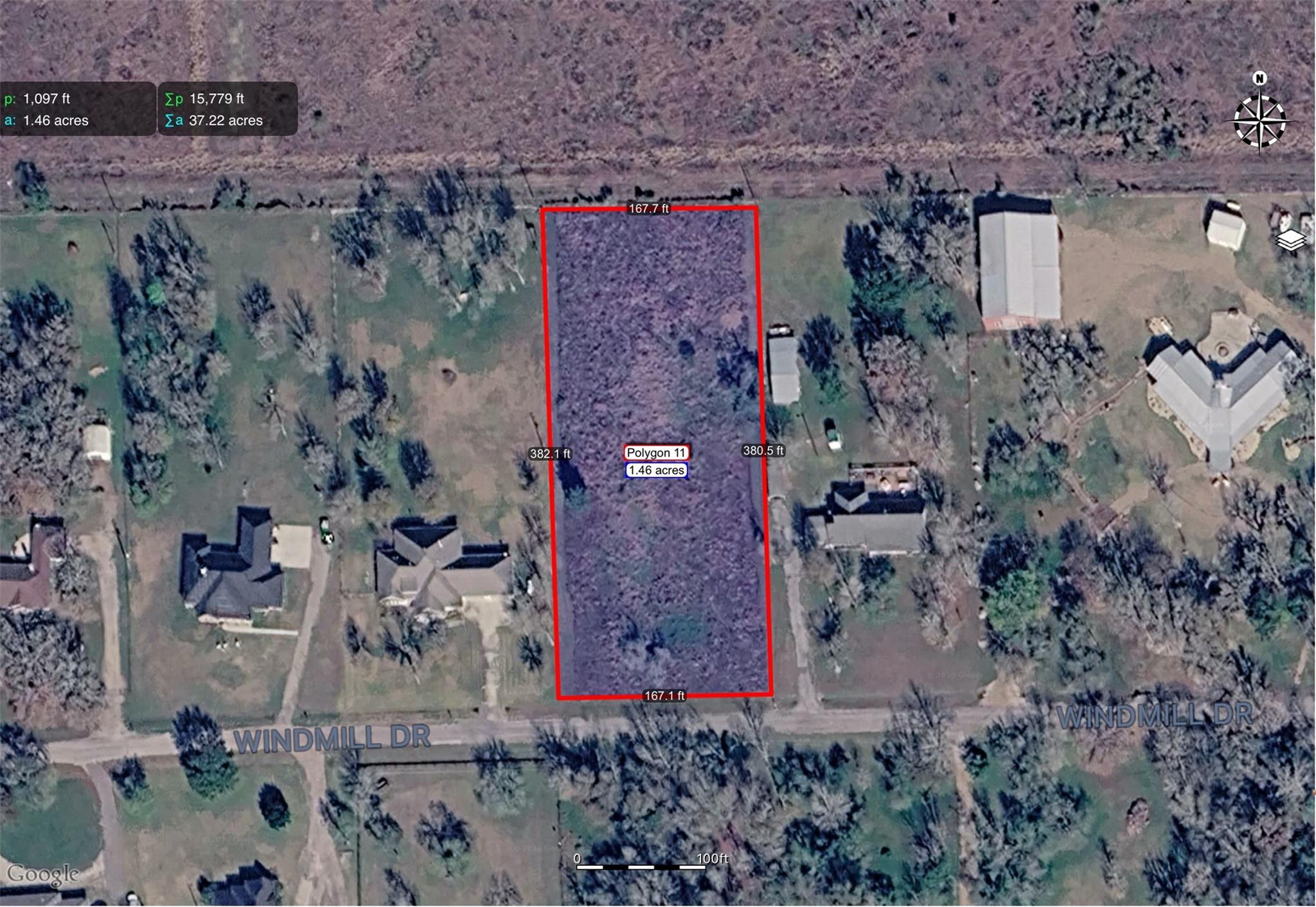 Aerial view of a wooded 1.46-acre parcel outlined in red along Windmill Drive.