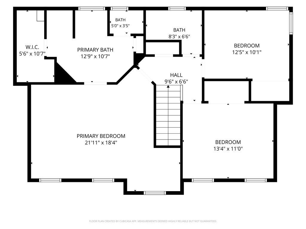 Floor plan with a primary bedroom, two bedrooms, bathrooms, walk-in closet, hall, and stairs.