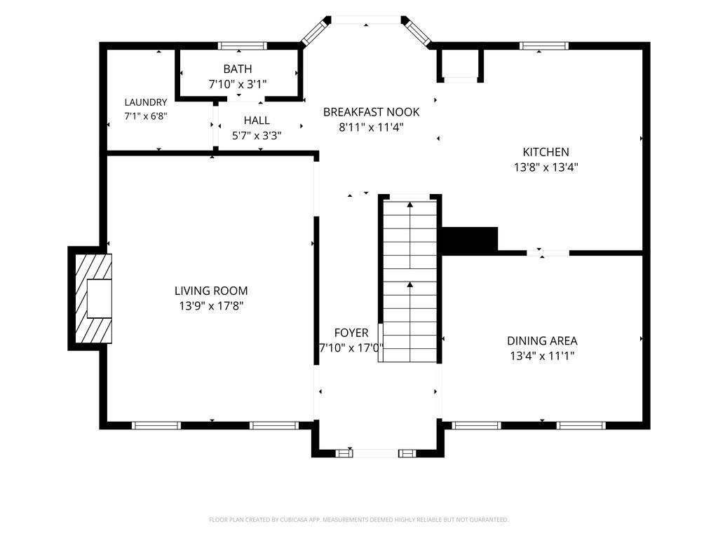 First-floor plan showing living room, kitchen, dining area, breakfast nook, laundry, bath, and central staircase.