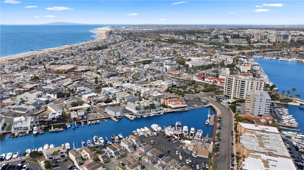 Aerial view of Newport Beach coastline and marina, with boats clustered in the harbor.