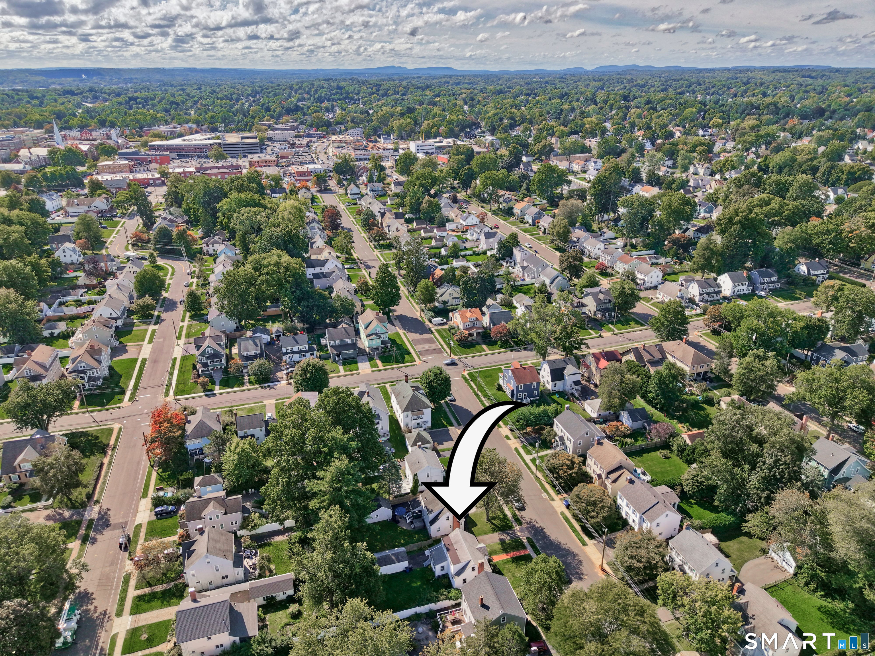 Aerial neighborhood view with an arrow pointing to the home at 102 Brunswick Avenue.