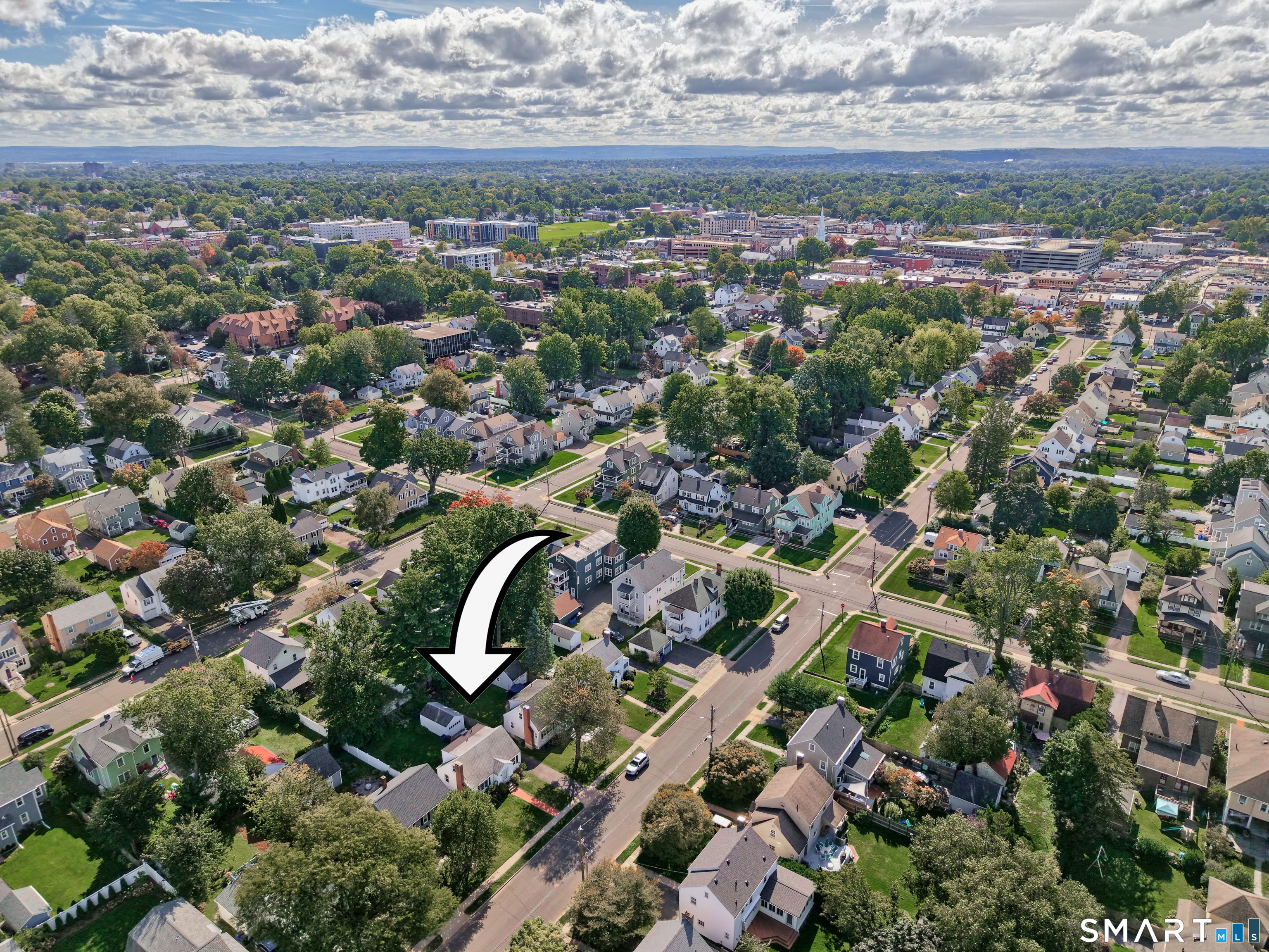 Aerial neighborhood view with an arrow pointing to the home at 102 Brunswick Avenue.