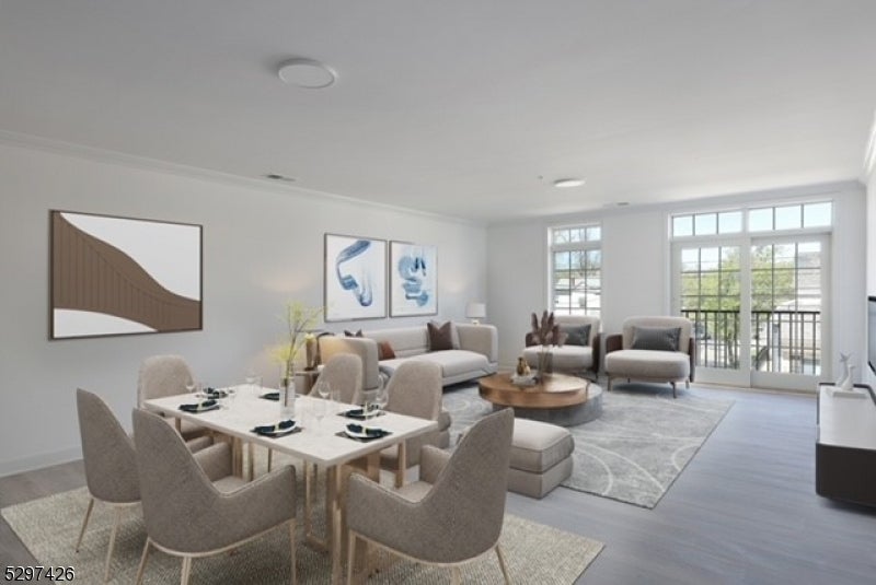 Open-plan living and dining room with neutral furnishings and glass balcony doors.