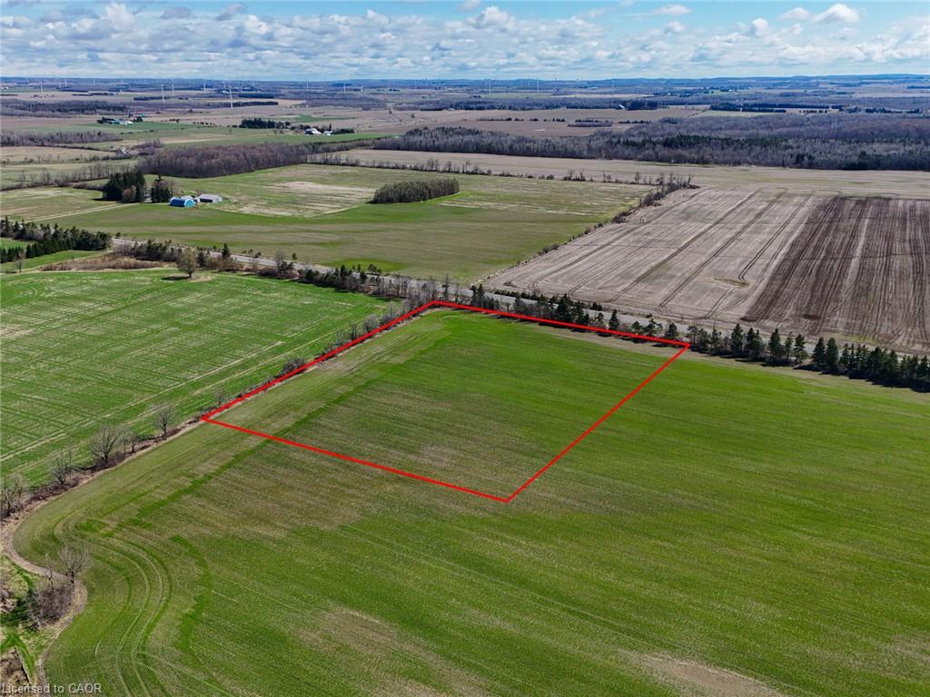 Aerial view of a marked agricultural parcel amid rural fields.