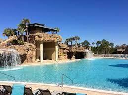 Swimming pool with a rocky waterfall, grotto, and lounge chairs.