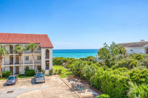 Coastal condominium with landscaped grounds and a Gulf of Mexico view.