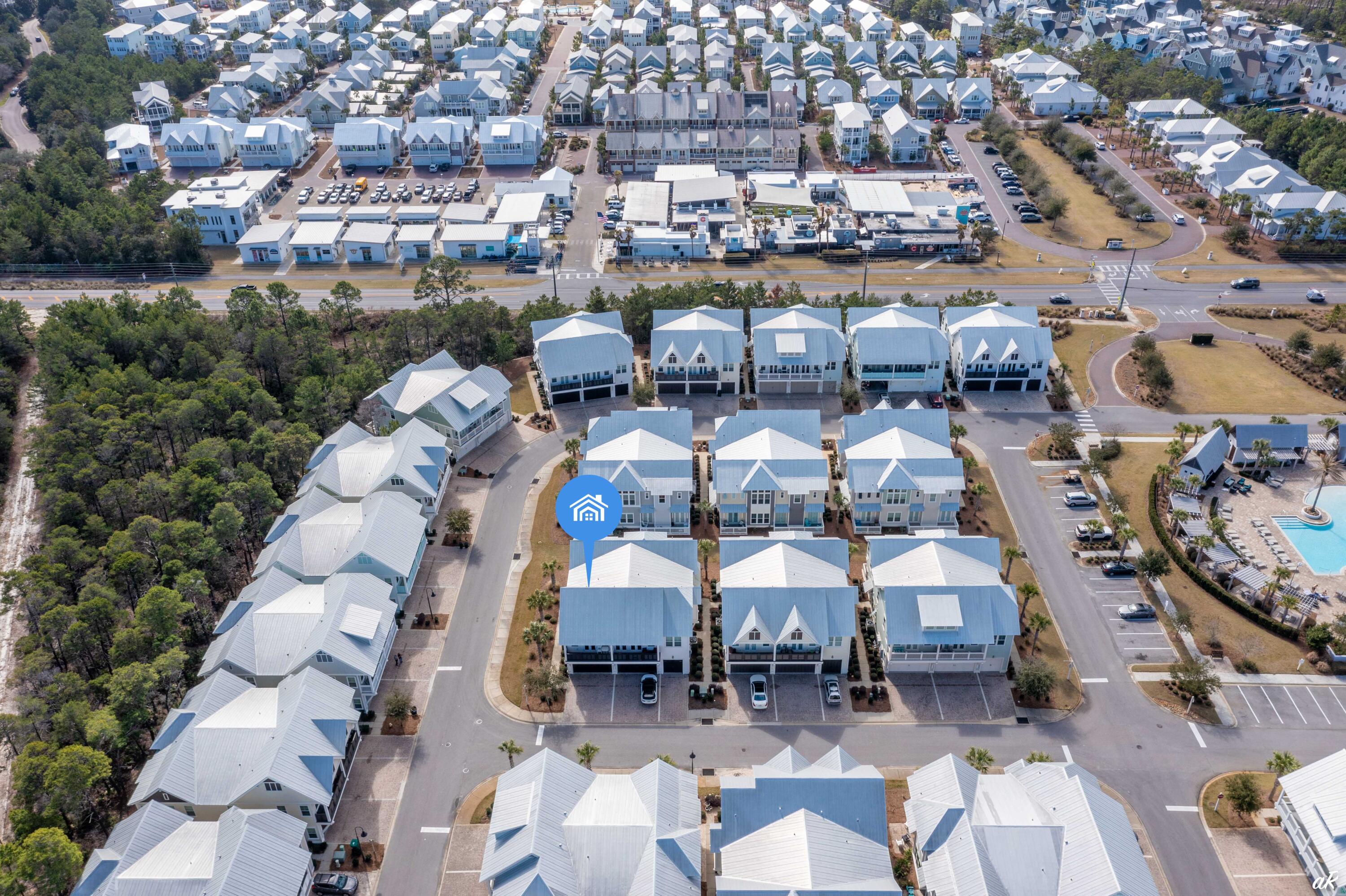Aerial view of a light-roofed home in a planned neighborhood, marked by a blue map pin.