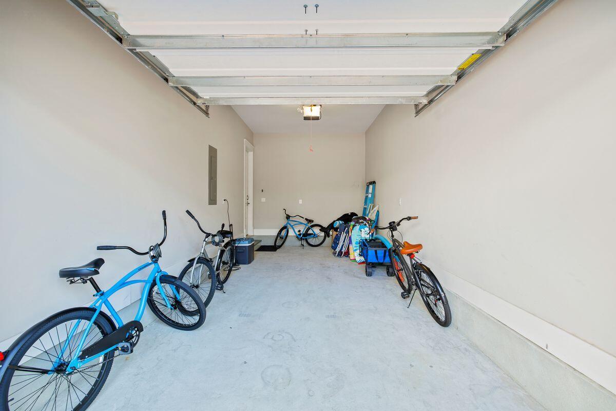 Garage with several bicycles and beach gear stored along the back wall.