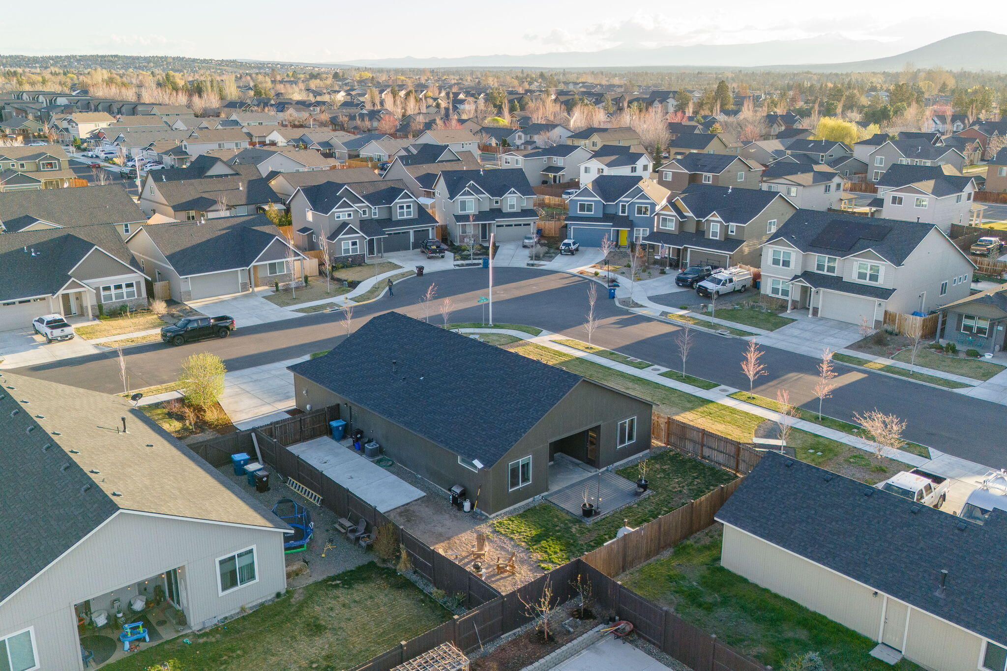 Aerial view of a fenced home and surrounding neighborhood.