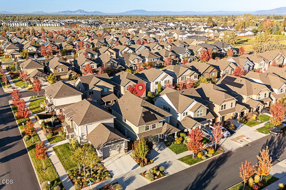 Aerial view of a suburban neighborhood with the listed home marked by a red pin.