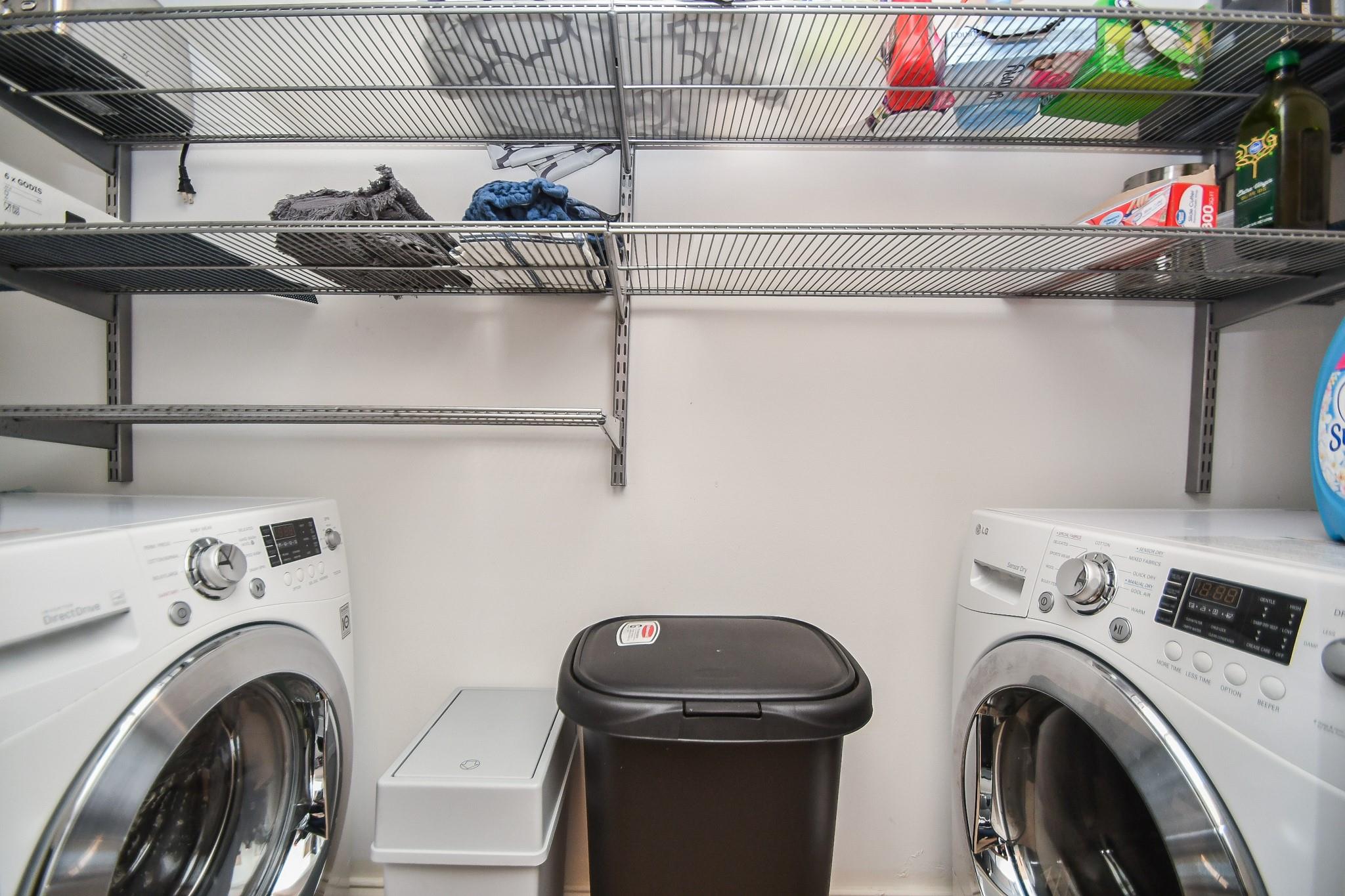 Laundry room with front-loading washer and dryer, utility sink, and wire storage shelves.