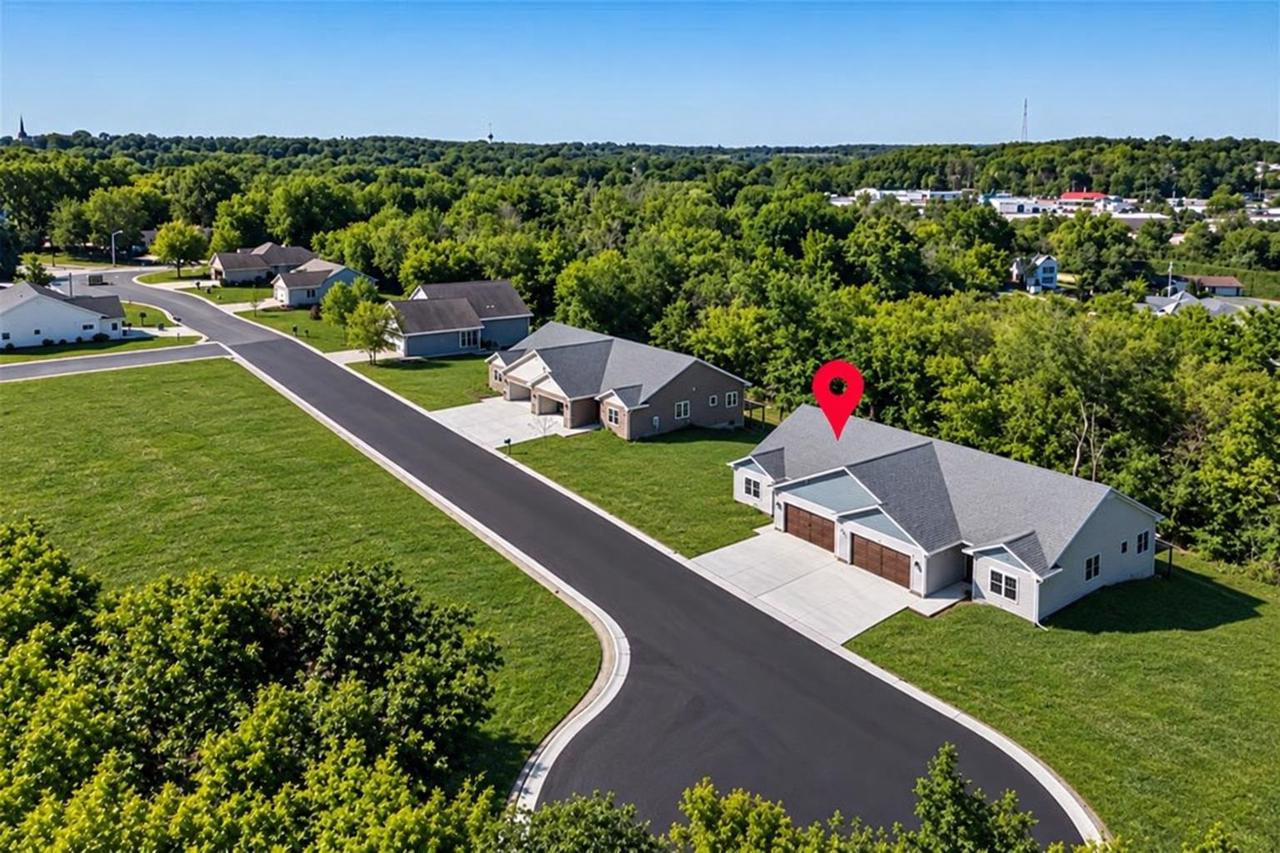 Aerial view of Ripon homes along a curving street, with a red location marker.