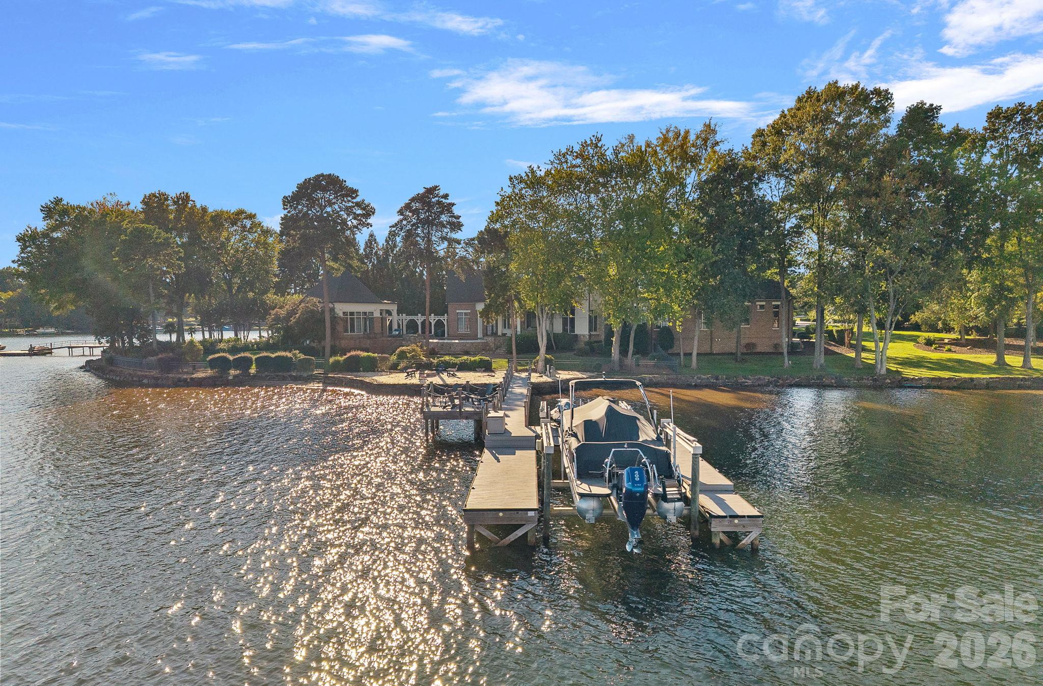 Waterfront home with a long dock and motorboat on the lake