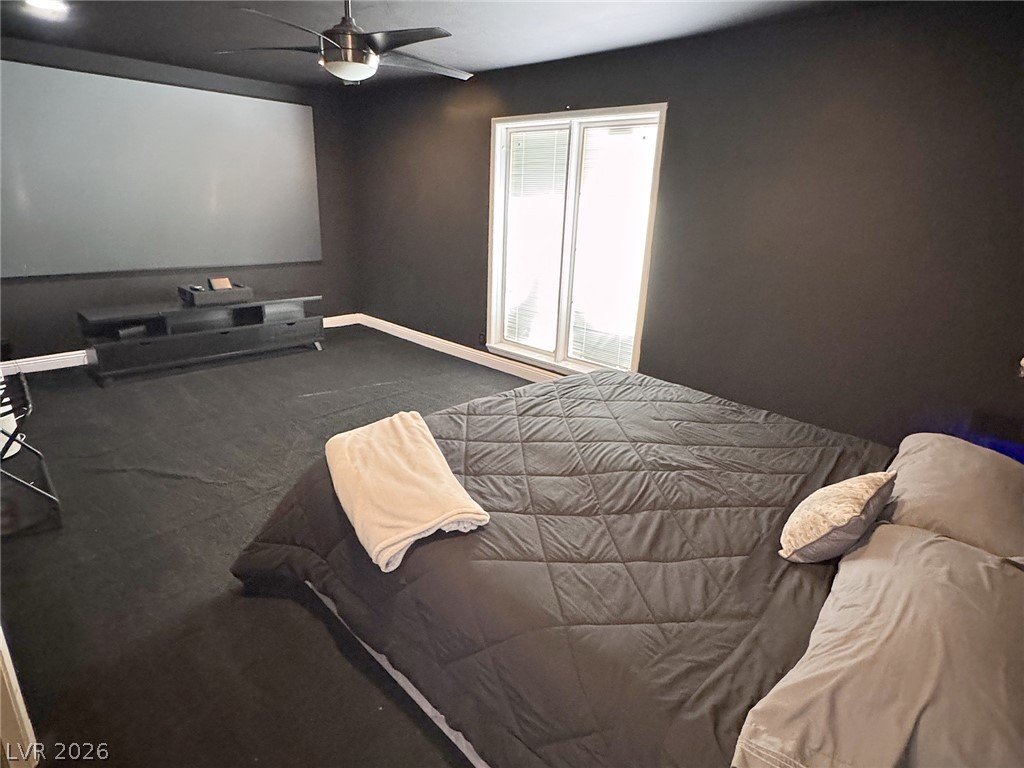 Media room with a large projection screen and gray sectional sofa.