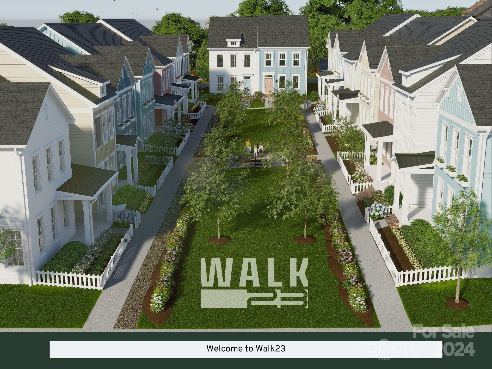 Walk23 townhome community surrounds a landscaped central lawn with walking paths and flower beds.