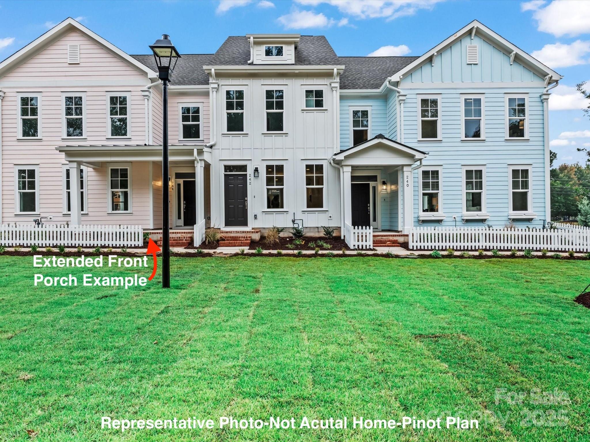 Three pastel townhomes with white picket fencing; a label points out an extended front porch.