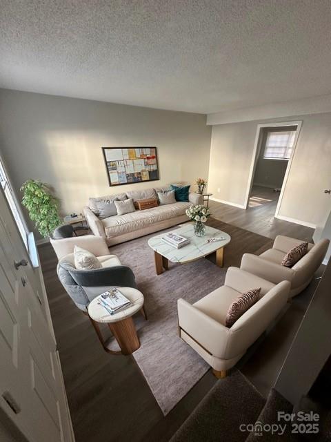 Staged living room with a cream sofa, two armchairs, and a marble-look coffee table.