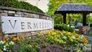 Vermillion community entrance sign surrounded by flowers and landscaping.