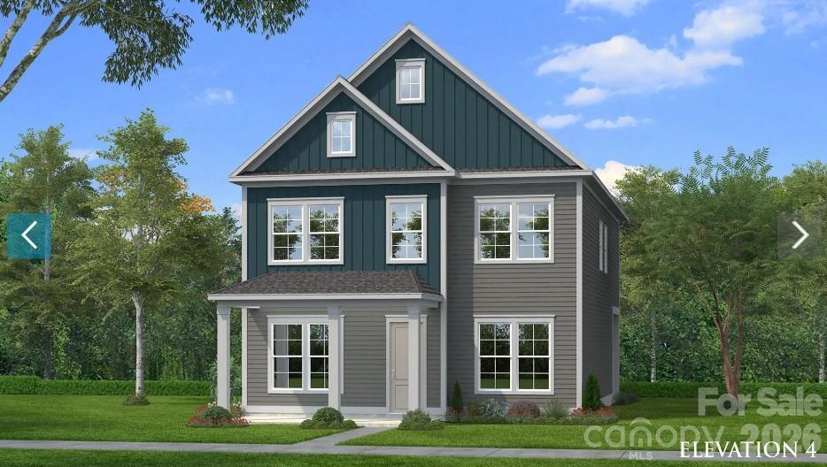 Two-story gray house with dark teal gables, white trim, and a landscaped lawn.