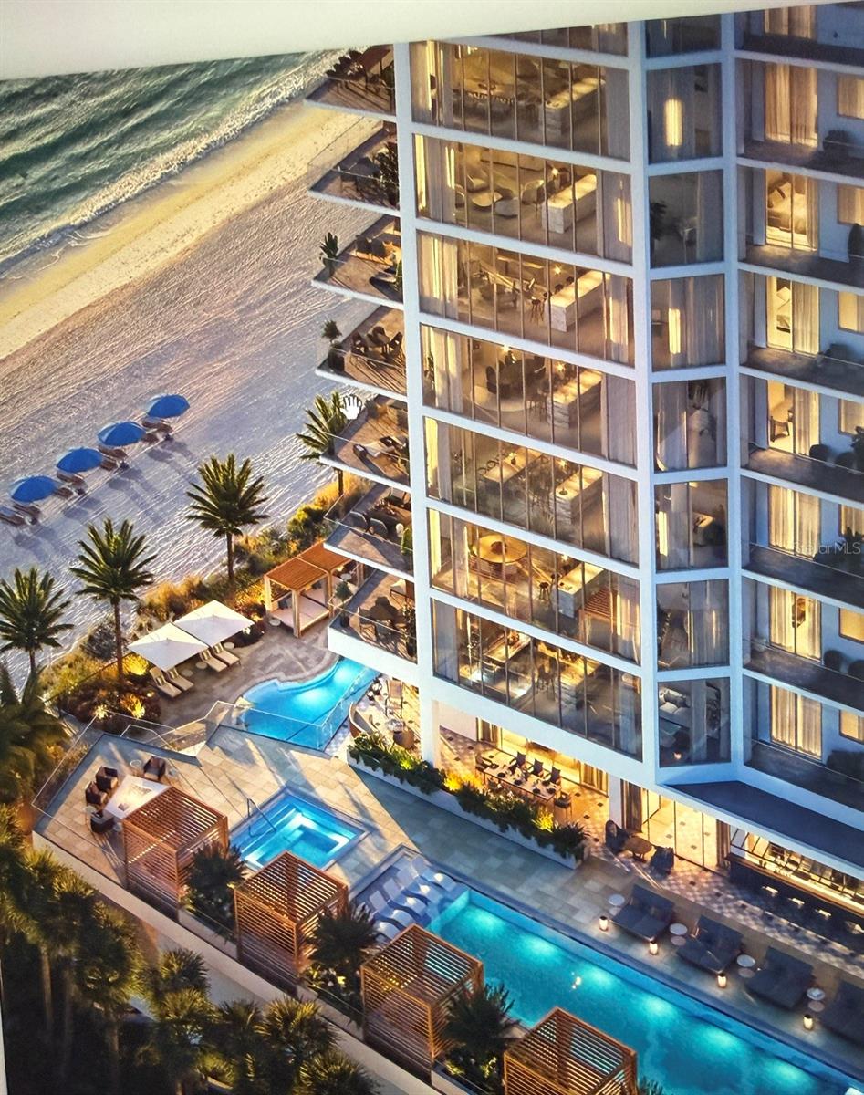 Beachfront high-rise with glass balconies, landscaped pool deck, and oceanfront beach.