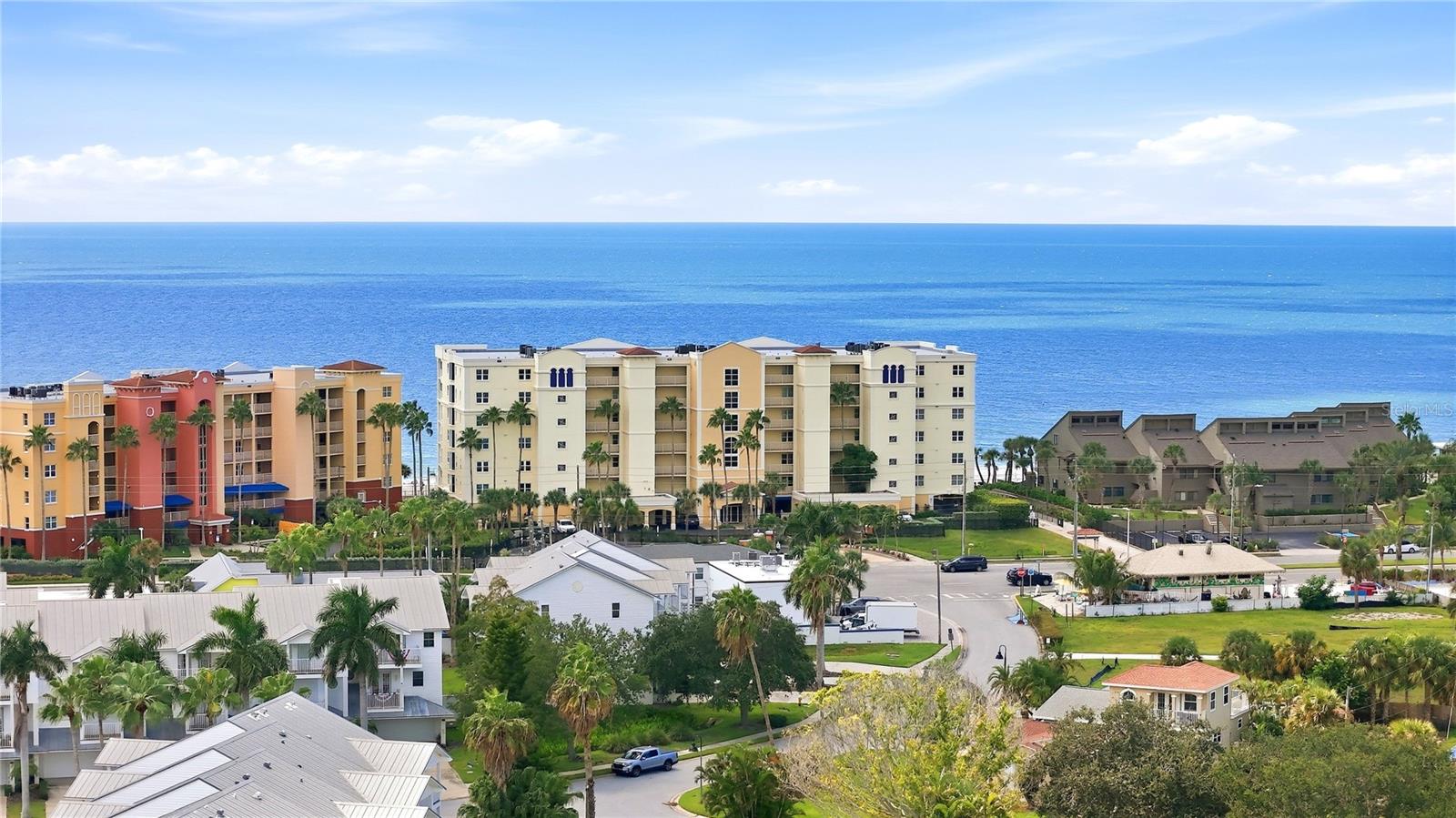North Redington Beach condos and palm-lined homes beside the blue Gulf of Mexico.