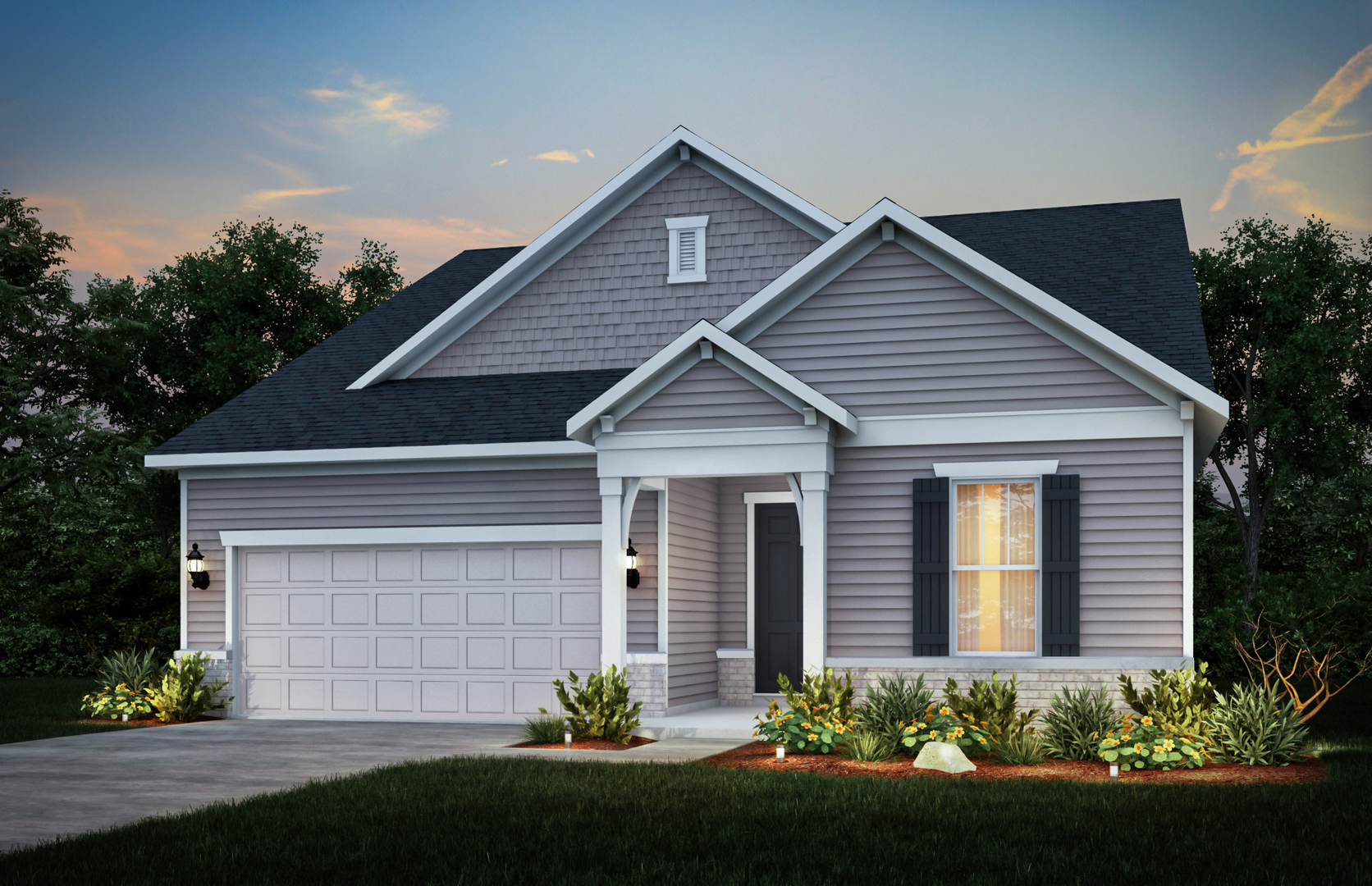 Single-story gray home with a two-car garage, gabled roof, and landscaped flower beds at dusk.