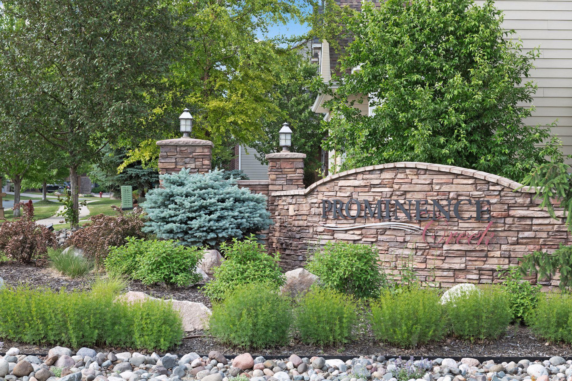 Prominence Creek neighborhood entrance sign on a landscaped stone wall
